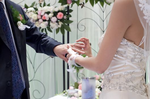a young couple exchange ring on their wedding day