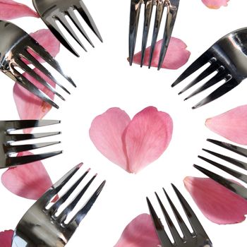 forks surrounding a heart shape petal with rose petals for a concept on romantic dining on white background