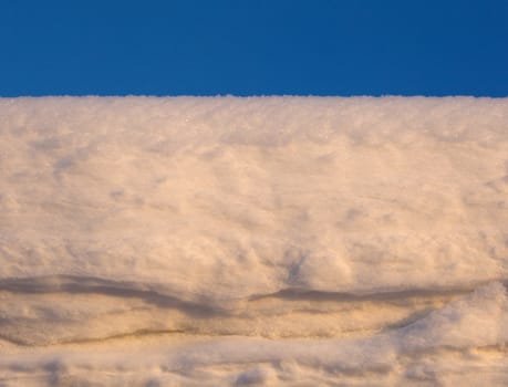 Snow white against the blue sky. Winter landscape