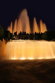 details group tourists photographing fountain in city Barcelona, Spain