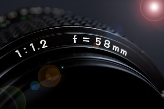 58mm 1.2 lens closeup with flare on black background