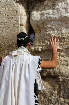 Unidentified man in tefillin  praying at the Wailing wall (Western wall). Jerusalem. Israel