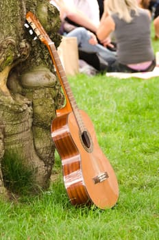 guitar against the tree in the open air festival