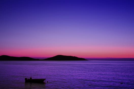 the sea at sunrise and boat