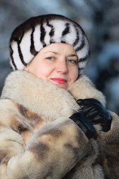 The woman of average years in a winter fur coat