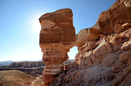 desert landscape under bright blue sky and sun