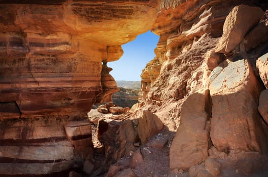 Narrow slot between two rocks in desert canyon