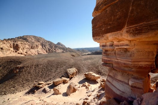 Rocky desert landscape under blue bright sky