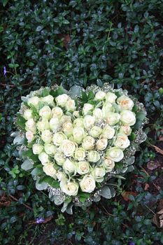 Heart shaped sympathy flower arrangement with white roses