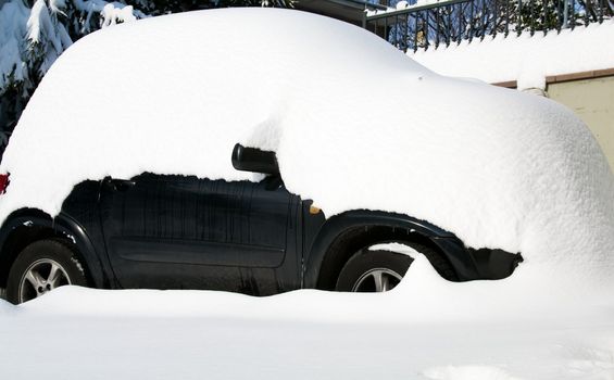 Car hidden in snow a winter day at Castelvetro