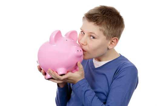 boy kissing pink piggybank on white background