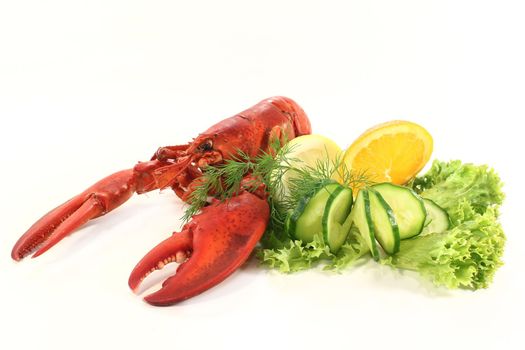 a lobster with salad, orange and cucumber