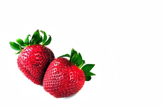 Two colorful tasty strawberries on white background. 