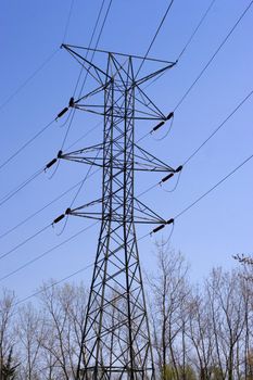 Some high power lines over a bright blue sky.