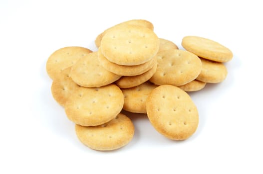 A pile of salted crackers isolated on white.