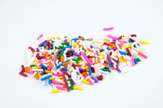 A pile of colored sprinkles isolated on white.