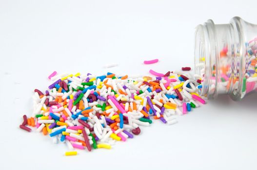 A pile of spilled sprinkles isolated on white.