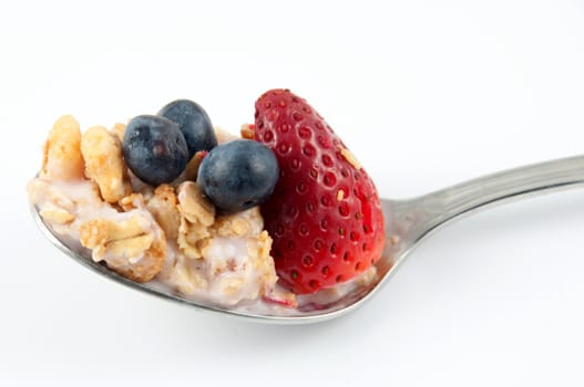 A bowl with yogurt, granola and fruits.