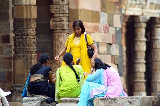 four asian women wearing beautiful sari