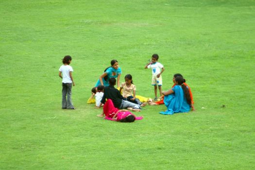 asian familly relax on the grass