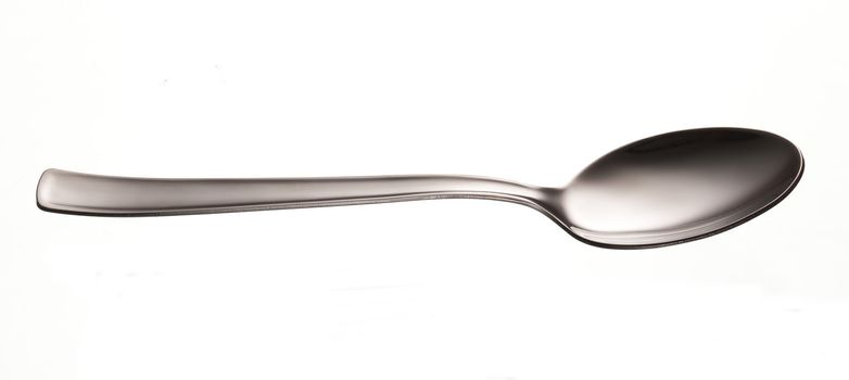 silver shiny kitchen table spoon over white
