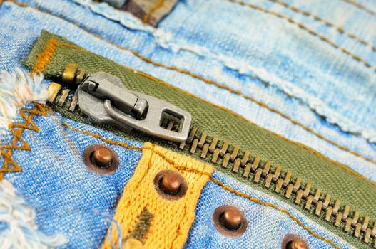 Zipper on the pocket of jeans. Macro photo.