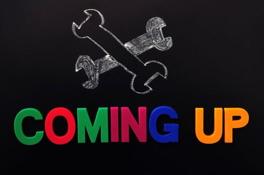 Under construction and coming up concept on a blackboard