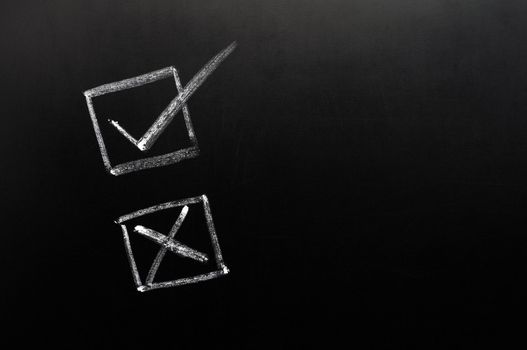 Tick and cross check boxes on a blackboard