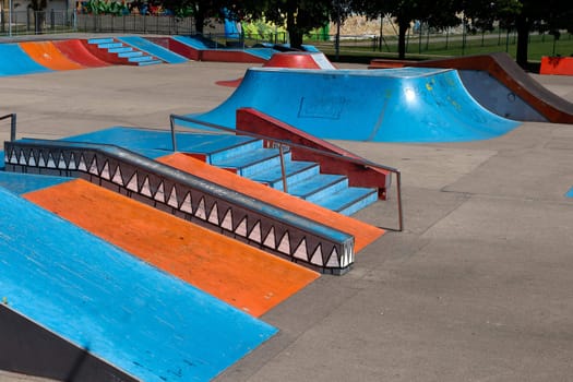 A empty skate park with ramps and other elements