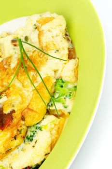 Delicious Omelet with Broccoli and Spring Onion on Green Plate closeup