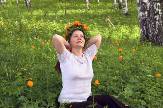 Woman with flowers in a forest glade