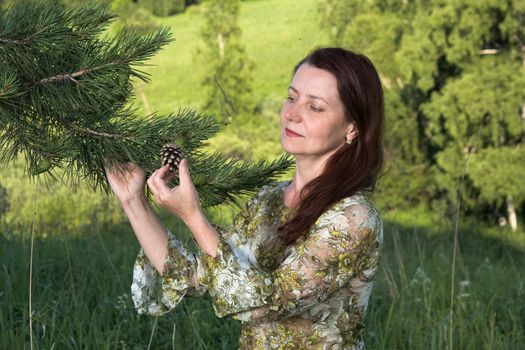 Portrait of the woman with a pine branch