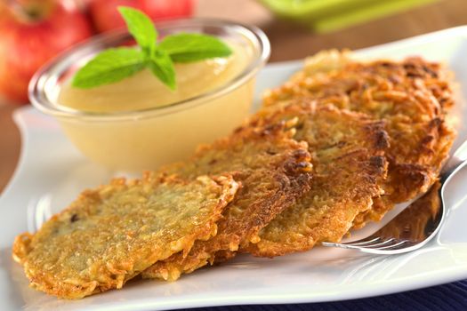 Potato fritters with apple sauce (Selective Focus, Focus on the front edge of the fritters in the front)