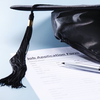 stock image of the mortar board and job application form