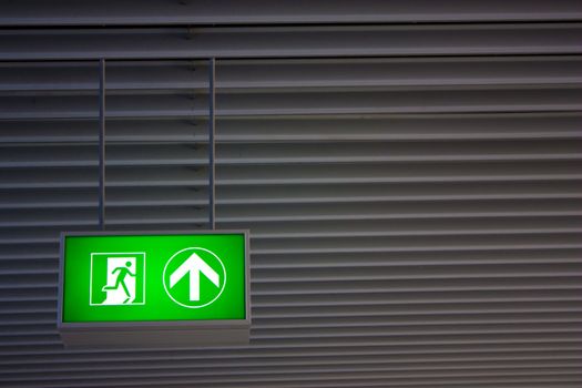 Emergency exit sign in modern offices inside an industrial plant