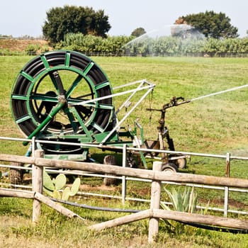 Irrigation operations in Italian country during a sunny day