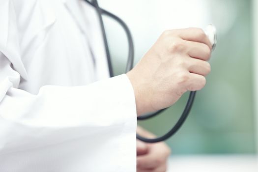 Close-up photo of the doctor hand holding stethoscope