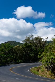 Yellow curve Line on the way up to mountain and bright sky white cloud