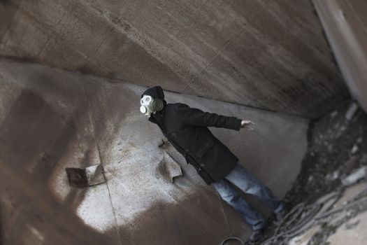 Human in gas mask standing at the industrial place