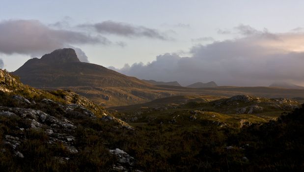 big scottish mountain with wetland in evening light