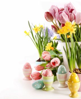 Easter eggs  with spring flowers on white background