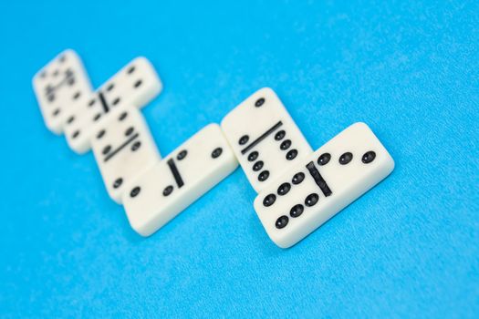 Closeup photo of domino bricks on blue background