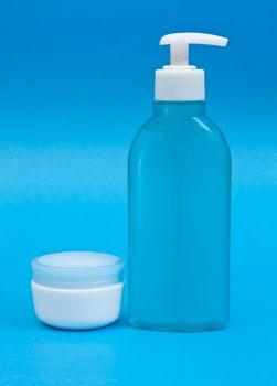 Plastic clean shampoo bottle isolated on a blue background