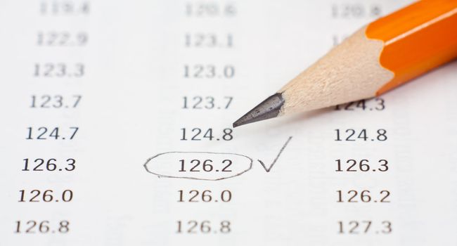 Closeup photo of pencil on a table with nimbers.