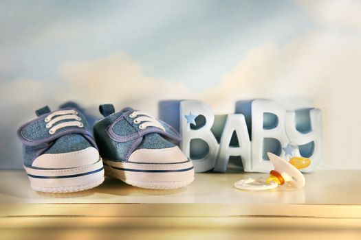 Little baby denim running shoes with pacifier on shelf