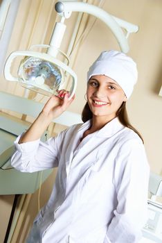 portrait of a beautiful young female dentist in her office