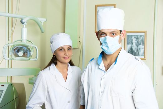 portrait of two young doctors looking at camera in dentistry office 