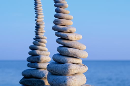 Two pile of pebbles in the balance on the seacoast