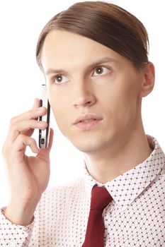 Serious businessman talking via cell phone on a white background