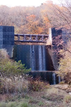 A Japananese autumn landscape with an artificial waterfall

